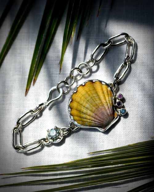 Hawaiian sunrise shell bracelet with large moissanite, blue topaz, Brazilian amethyst and pink sapphire accents in sterling silver