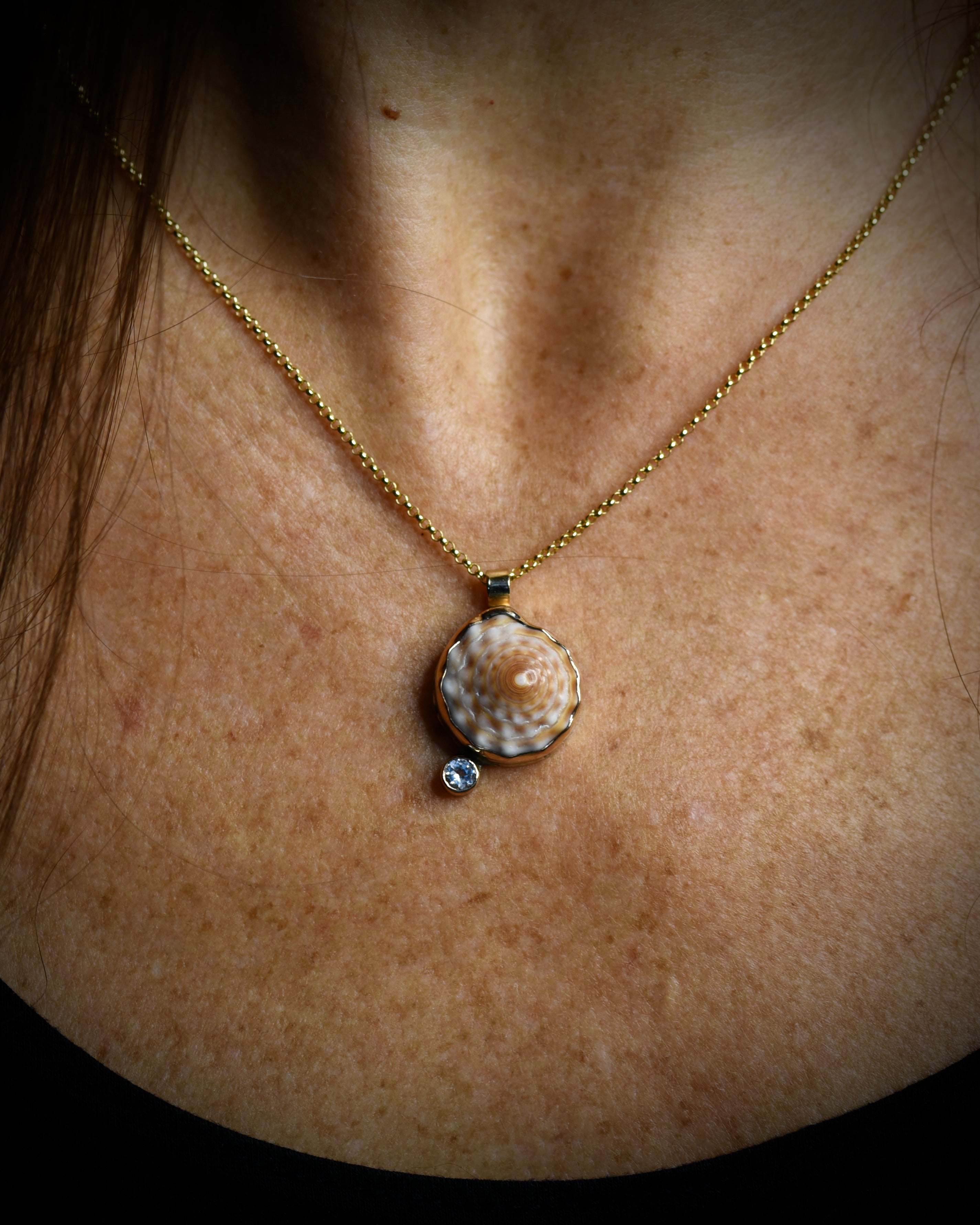 Midi Puka Dot necklace with mottled cream and brown Hawaiian puka shell and topaz accent worn on an 18-inch gold-filled chain
