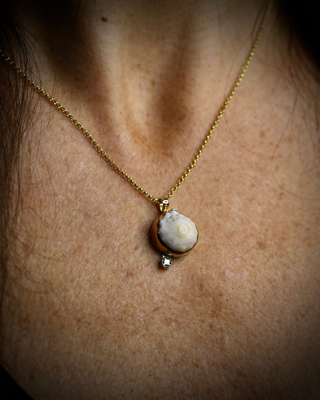 Petite Puka Dot necklace with cream and tan Hawaiian puka shell and topaz accent worn on an 18-inch gold-filled chain
