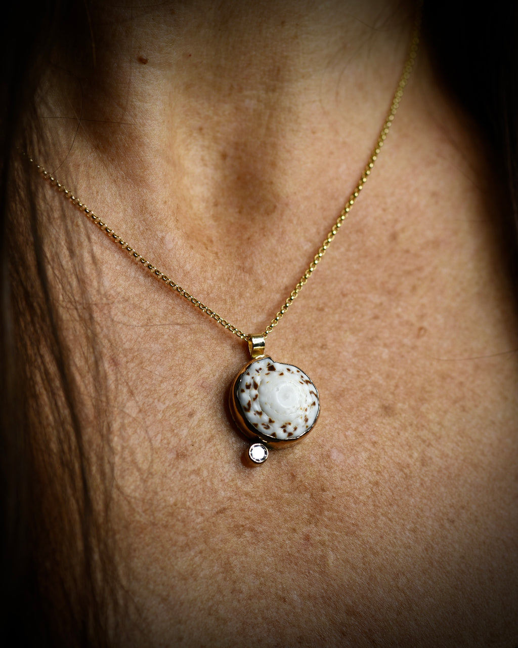 Midi Puka Dot necklace with white and brown Hawaiian puka shell and topaz accent worn on an 18-inch gold-filled chain