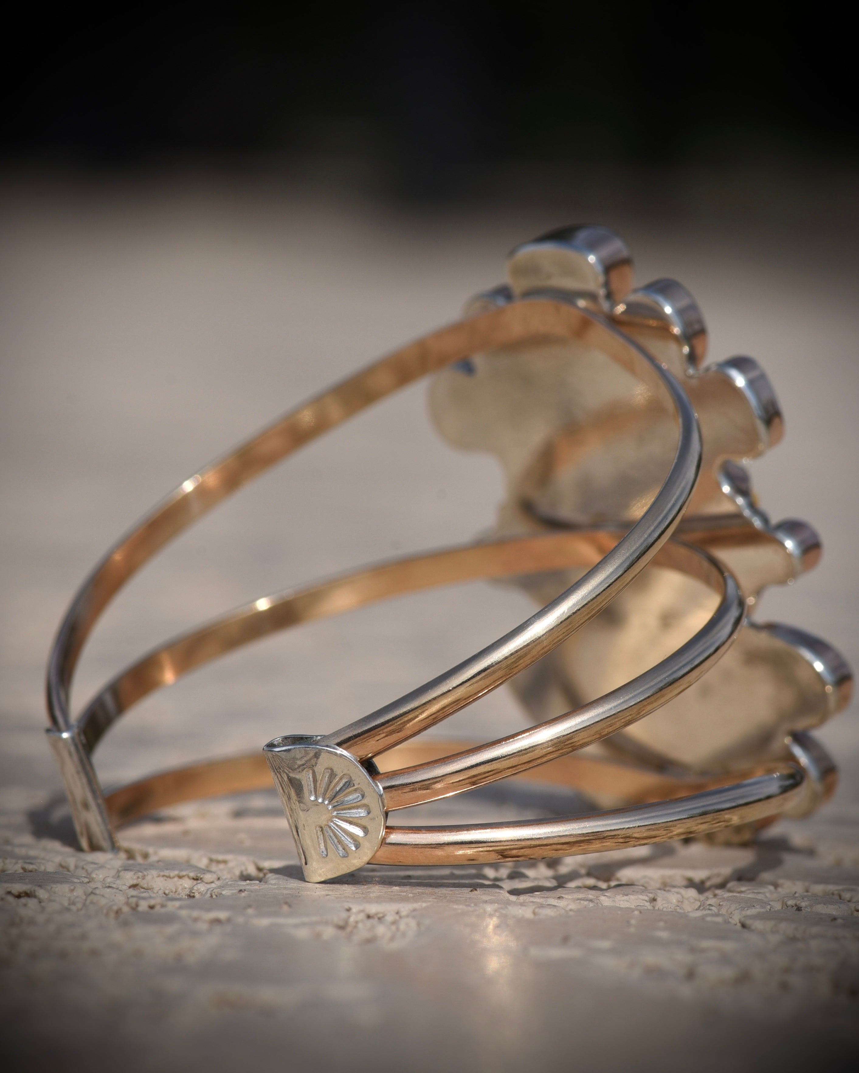 Back view of Reef Riot cuff showing the three 14K gold-filled bands and sterling silver end caps
