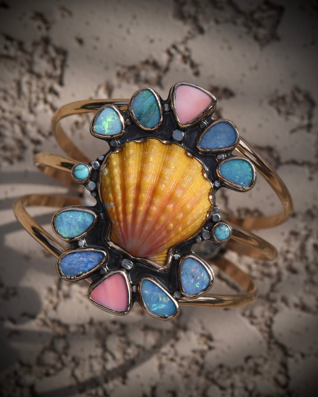 Reef Riot statement cuff with Hawaiian sunrise shell, Australian opals, Kingman turquoise, and pink conch in 14K gold fill
