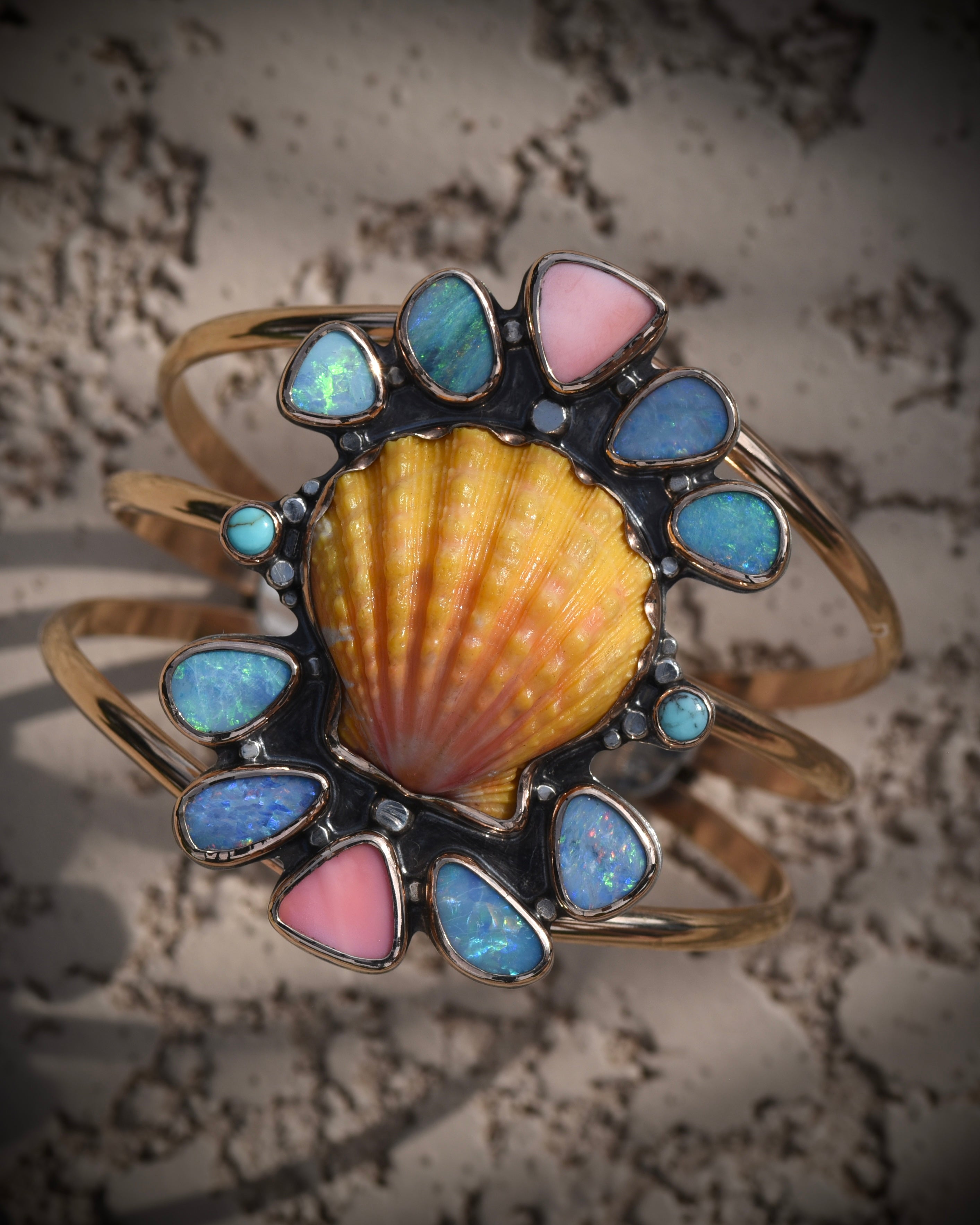Reef Riot statement cuff with Hawaiian sunrise shell, Australian opals, Kingman turquoise, and pink conch in 14K gold fill
