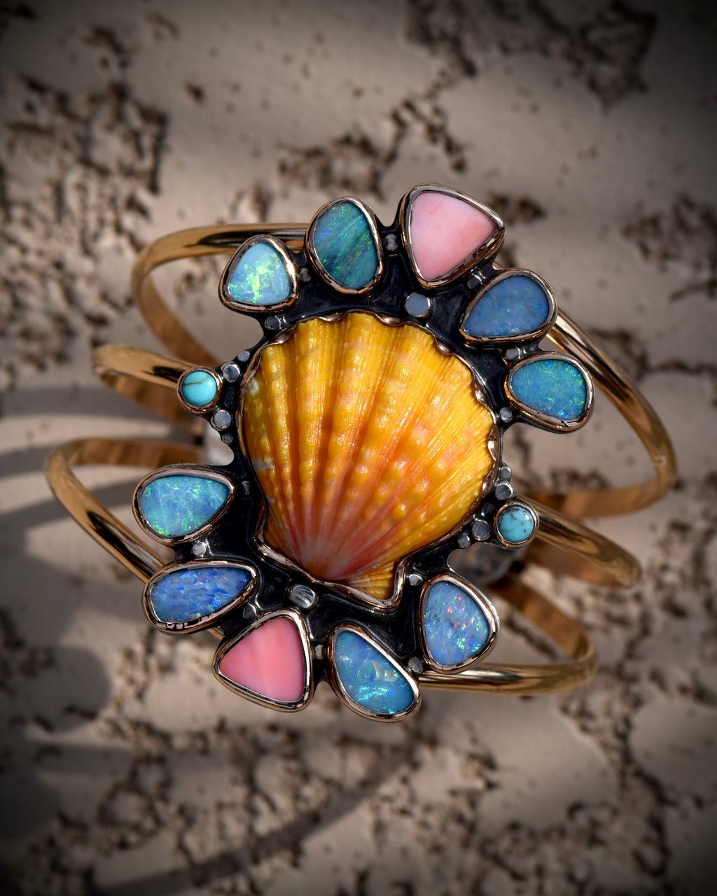Reef Riot statement cuff with Hawaiian sunrise shell, Australian opals, Kingman turquoise, and pink conch in 14K gold fill
