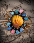 Reef Riot statement cuff with Hawaiian sunrise shell, Australian opals, Kingman turquoise, and pink conch in 14K gold fill