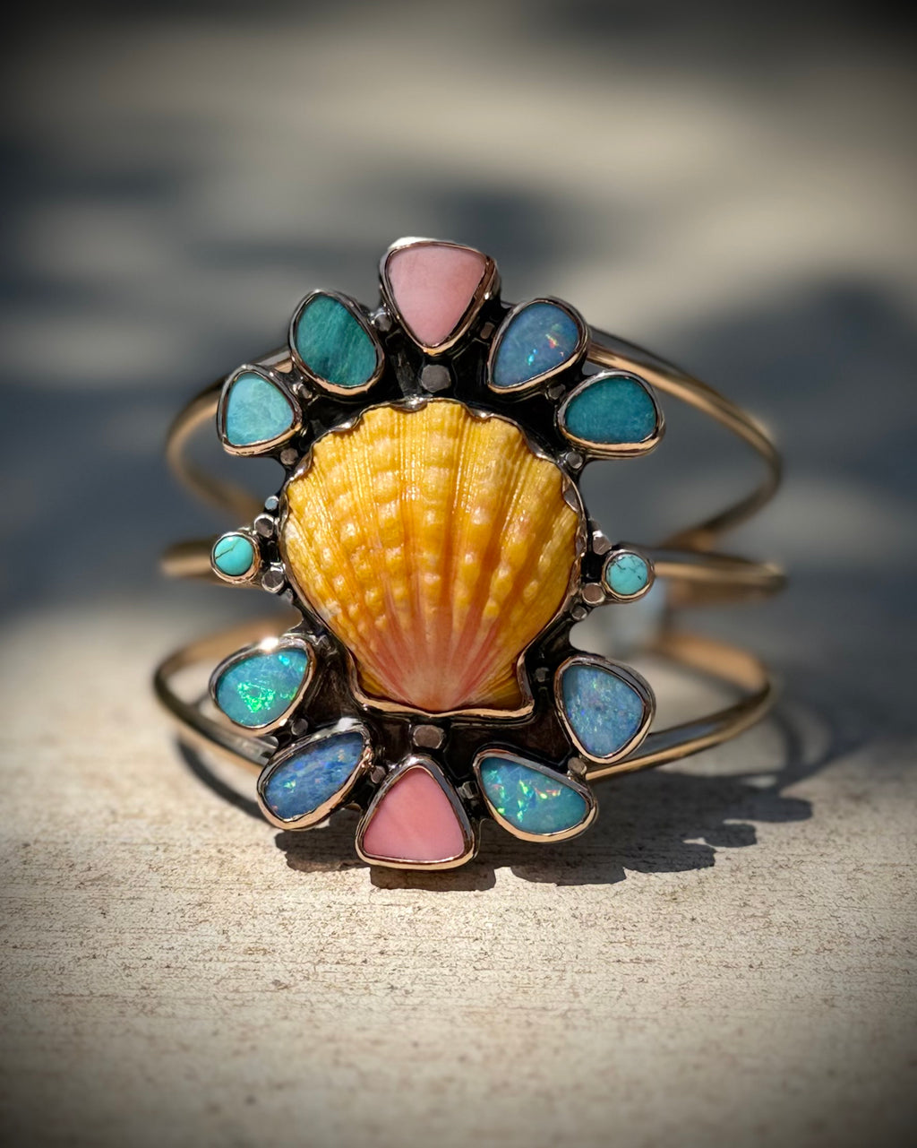 Reef Riot cuff displayed upright, showing the full colorful statement design
