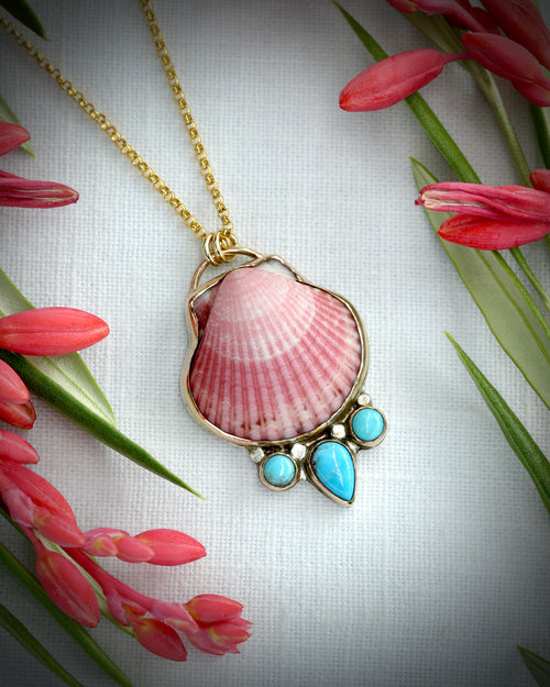 Pink scallop shell and turquoise pendant necklace in 14K gold fill, photographed with tropical flowers
